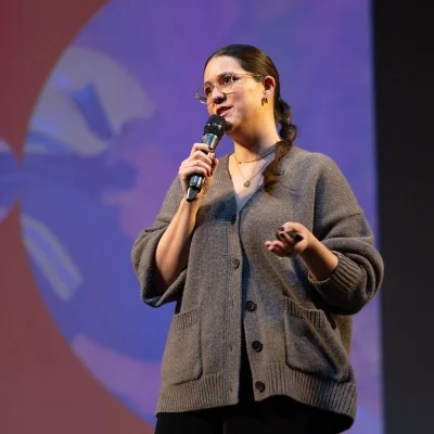 black n orange team member speaking at an industry event
